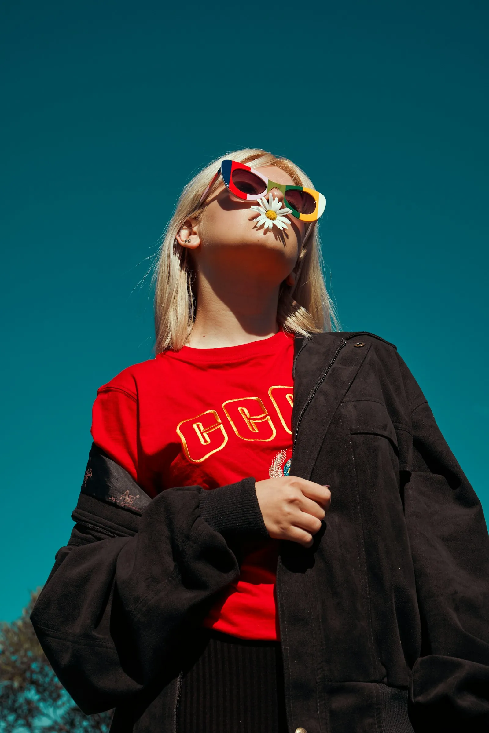 Campaign photo: sunglasses, red tee and suede jacket